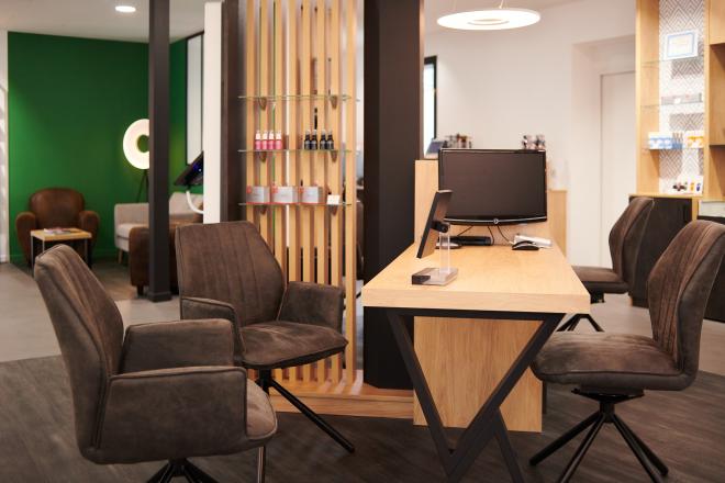 Repenser son agencement en diminuant son exposition tout en la mettant plus en valeur Et profiter de son extension pour accueillir au mieux ses clients Des mobiliers sur mesure bois/métal avec éclairage intégré Une salle d’examen de vue Un atelier ouvert sur l’espace de vente Un ilot de table de vente facilitant la circulation périphérique