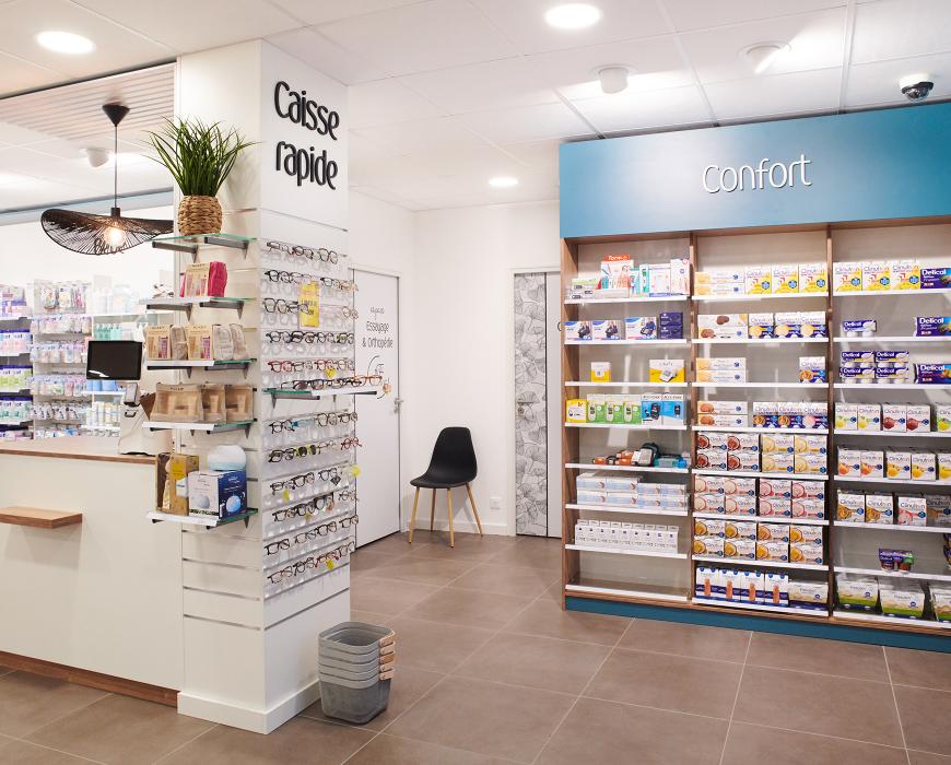 Zone caisse rapide et présentoir optique pour lunettes de lecture, aménagement d'un pôle confort avec assise design cyan.  