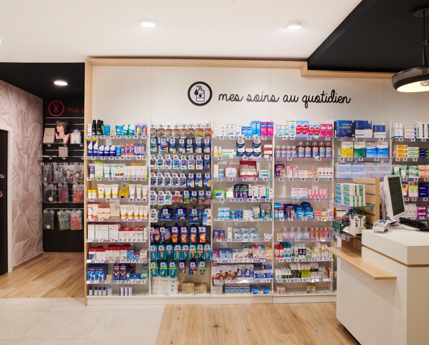 Aménagement intérieur de la pharmacie Monsieur Oliveira à Bouaye réalisé par JBCC, avec espaces de vente modernes, accueil, plots d’animation et cabines de confidentialité.